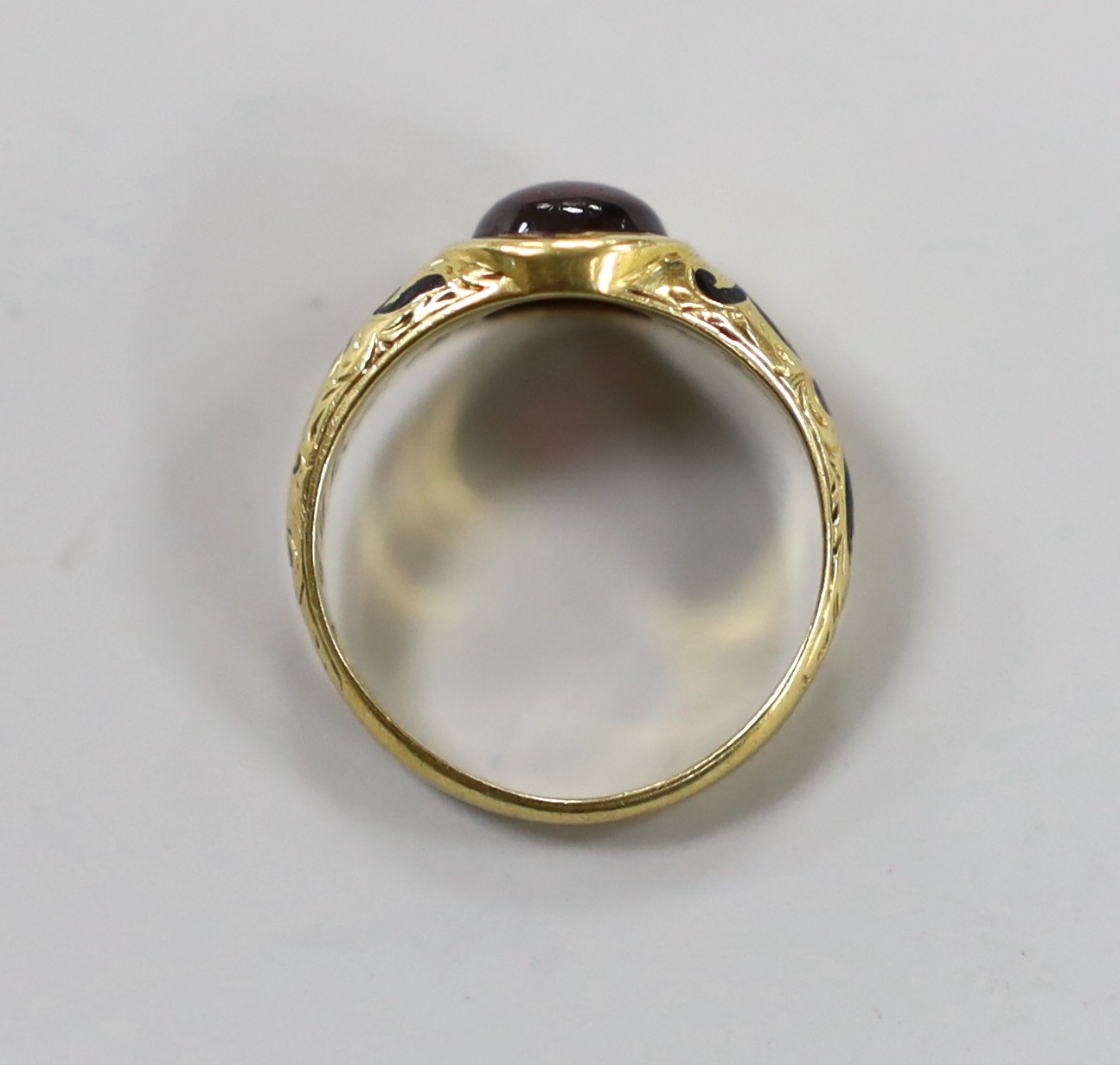 A Victorian 18ct gold, cabochon garnet and black enamel set memorial ring, the shank interior inscribed 'J W Scott obt. 26th Jan, 1851 at 41', size J, gross weight 2.8 grams.